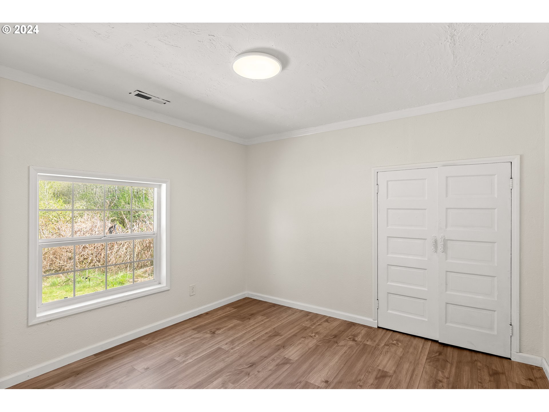 72523 Apiary Road Rainier, OR 97048 - Photo 15 of 23 a view of an empty room with wooden floor and a window