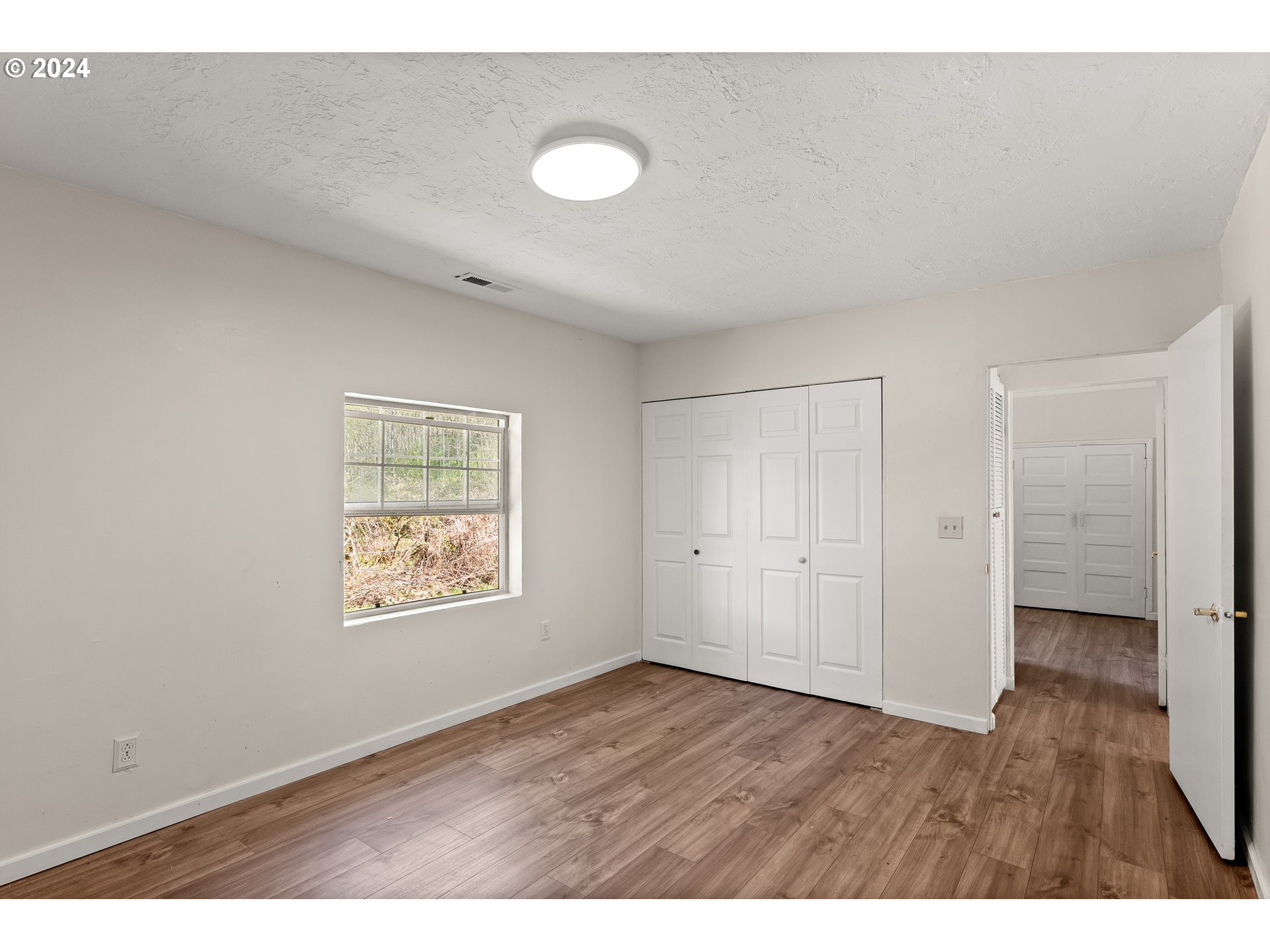 72523 Apiary Road Rainier, OR 97048 - Photo 17 of 23 a view of an empty room with wooden floor and a window