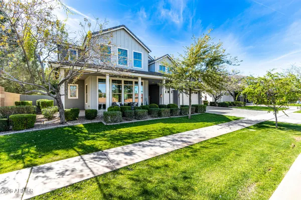 a front view of a house with a yard and trees