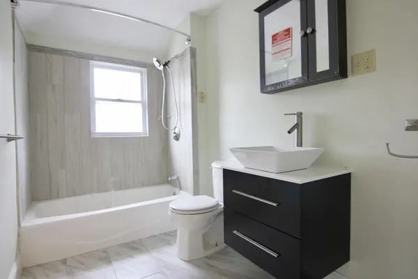 a bathroom with a toilet a sink and a shower