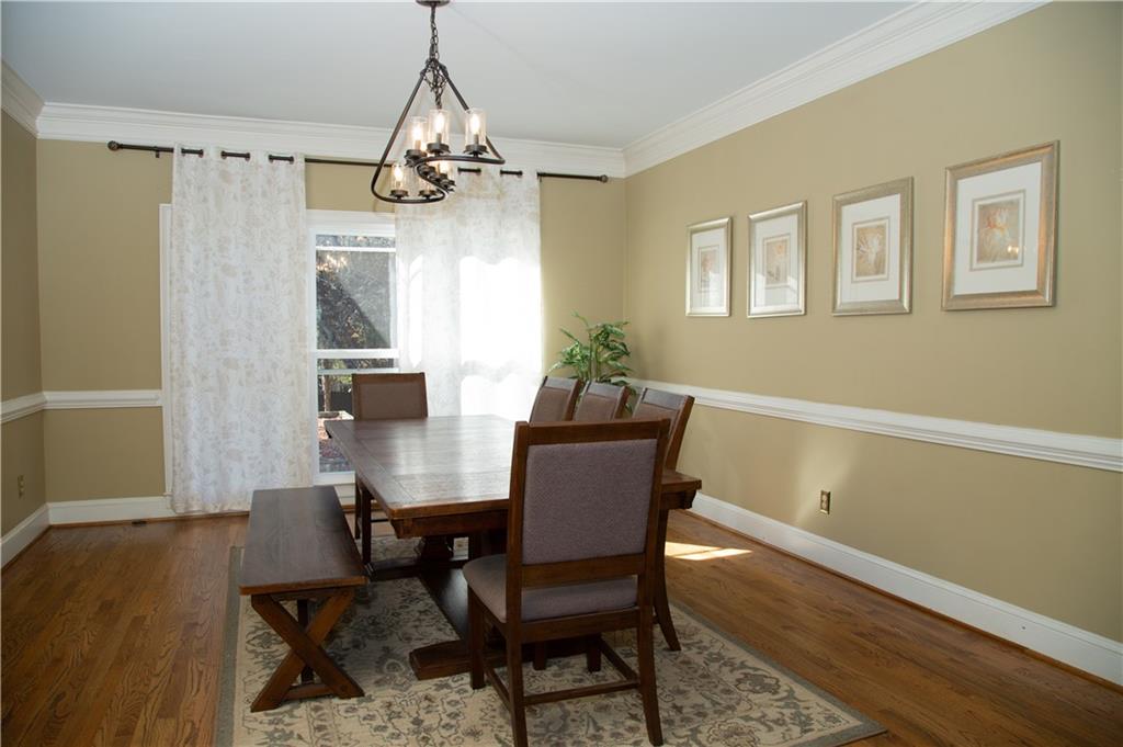 5735 Sunset Maple Drive Alpharetta, GA 30005 - Photo 12 of 39 a view of a dining room with furniture window and wooden floor