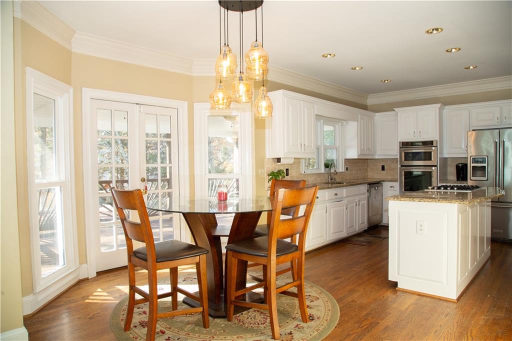 5735 Sunset Maple Drive Alpharetta, GA 30005 - Photo 18 of 39 a view of a dining room with furniture window and wooden floor