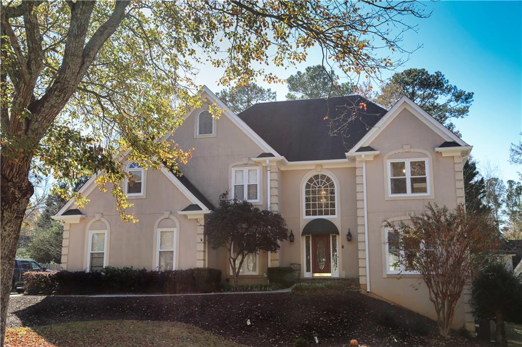 5735 Sunset Maple Drive Alpharetta, GA 30005 - Photo 2 of 39 a front view of a house with garden