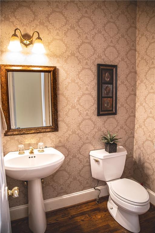 5735 Sunset Maple Drive Alpharetta, GA 30005 - Photo 22 of 39 a bathroom with a toilet sink and mirror