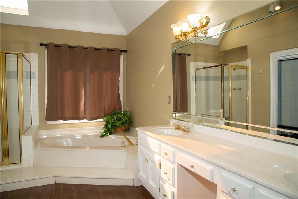 5735 Sunset Maple Drive Alpharetta, GA 30005 - Photo 27 of 39 a bathroom with a double vanity sink and a mirror
