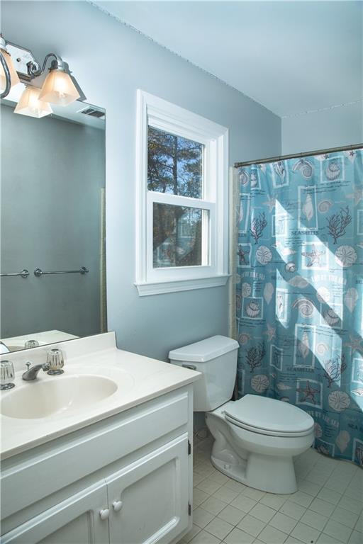 5735 Sunset Maple Drive Alpharetta, GA 30005 - Photo 30 of 39 a bathroom with a sink a toilet and shower