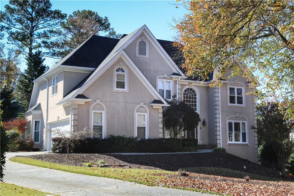 5735 Sunset Maple Drive Alpharetta, GA 30005 - Photo 3 of 39 a front view of a house with a yard