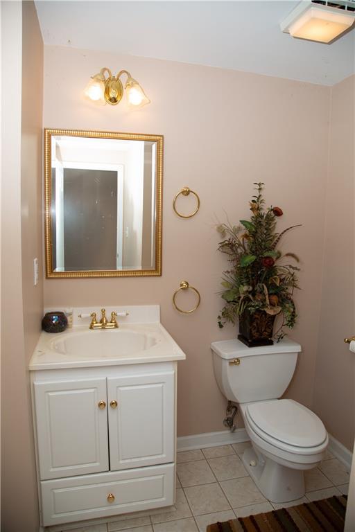 5735 Sunset Maple Drive Alpharetta, GA 30005 - Photo 31 of 39 a bathroom with a toilet sink and mirror