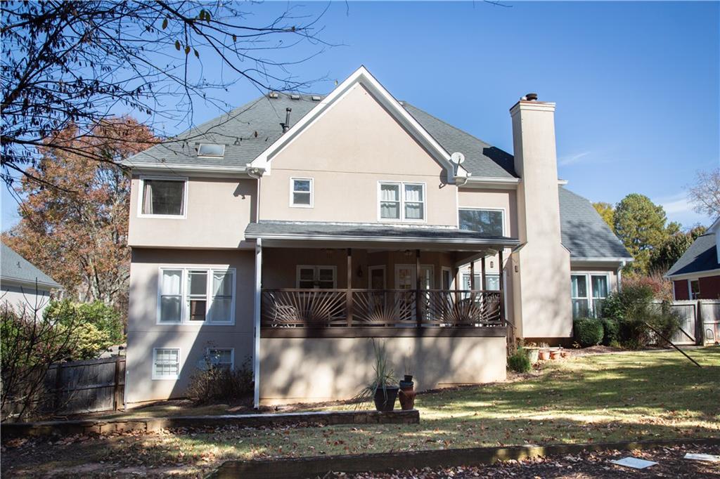 5735 Sunset Maple Drive Alpharetta, GA 30005 - Photo 5 of 39 a front view of a house with a yard