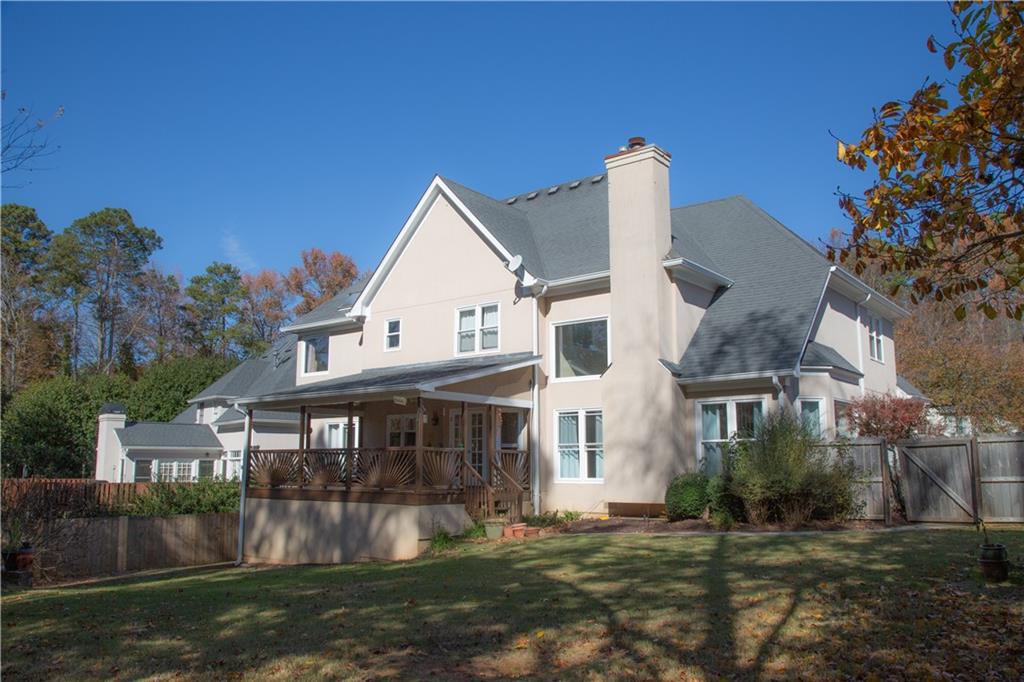 5735 Sunset Maple Drive Alpharetta, GA 30005 - Photo 6 of 39 a view of a big house with a big yard and large trees