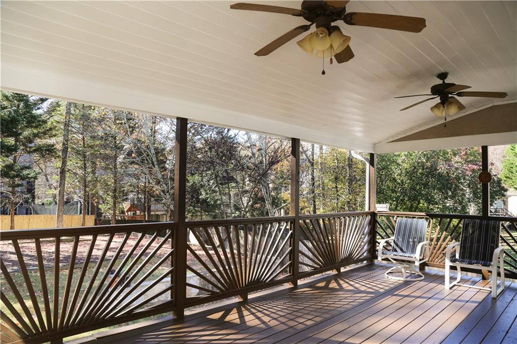 5735 Sunset Maple Drive Alpharetta, GA 30005 - Photo 7 of 39 a view of a balcony with wooden floor and iron stairs