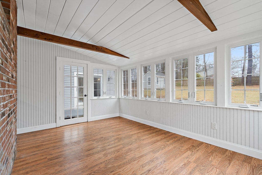 106 Lewis Avenue Walpole, MA 02081 - Photo 11 of 36 an empty room with wooden floor and windows
