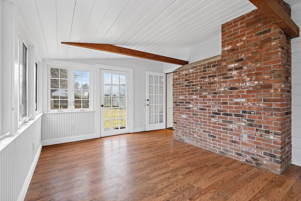 106 Lewis Avenue Walpole, MA 02081 - Photo 12 of 36 a view of an empty room with wooden floor and a window