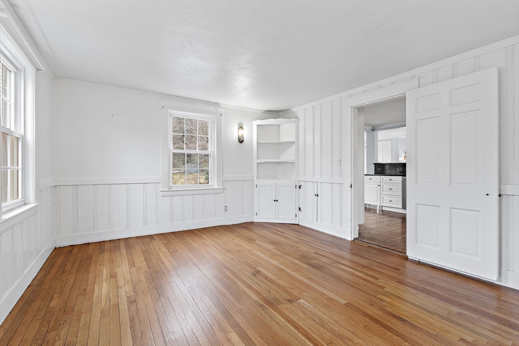 106 Lewis Avenue Walpole, MA 02081 - Photo 14 of 36 a view of an empty room with wooden floor and a window