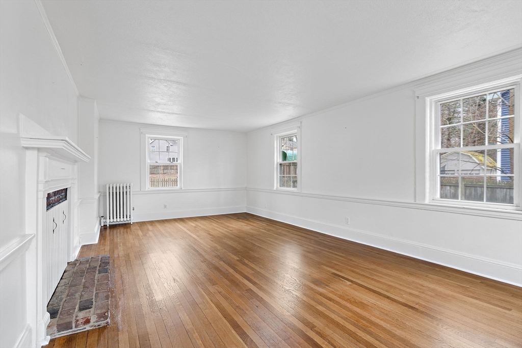106 Lewis Avenue Walpole, MA 02081 - Photo 16 of 36 an empty room with wooden floor and windows