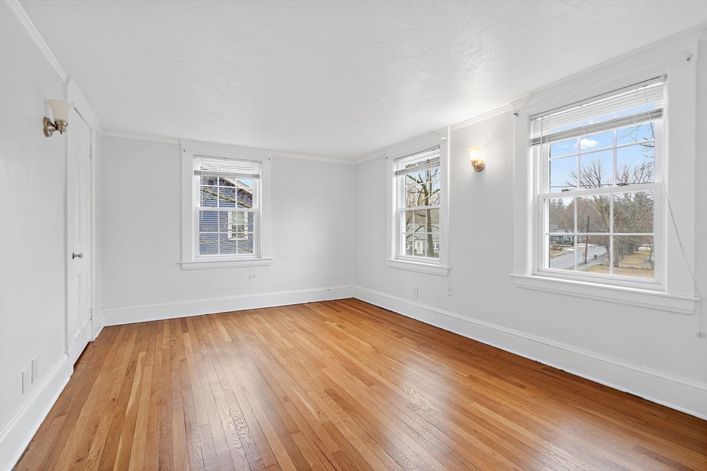 106 Lewis Avenue Walpole, MA 02081 - Photo 17 of 36 a view of empty room with wooden floor and fan