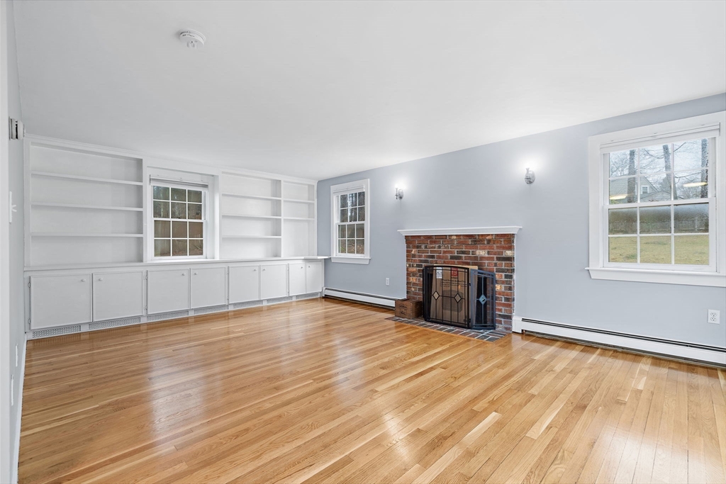106 Lewis Avenue Walpole, MA 02081 - Photo 19 of 36 a view of empty room with wooden floor and fireplace