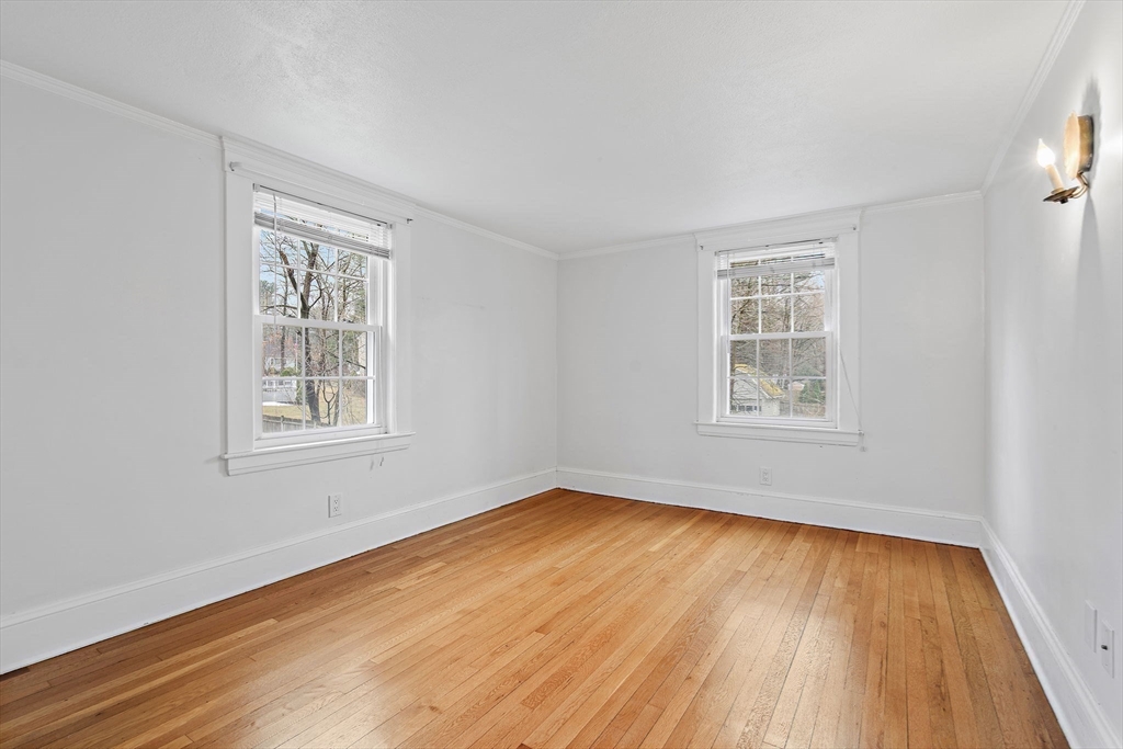 106 Lewis Avenue Walpole, MA 02081 - Photo 23 of 36 an empty room with wooden floor and windows