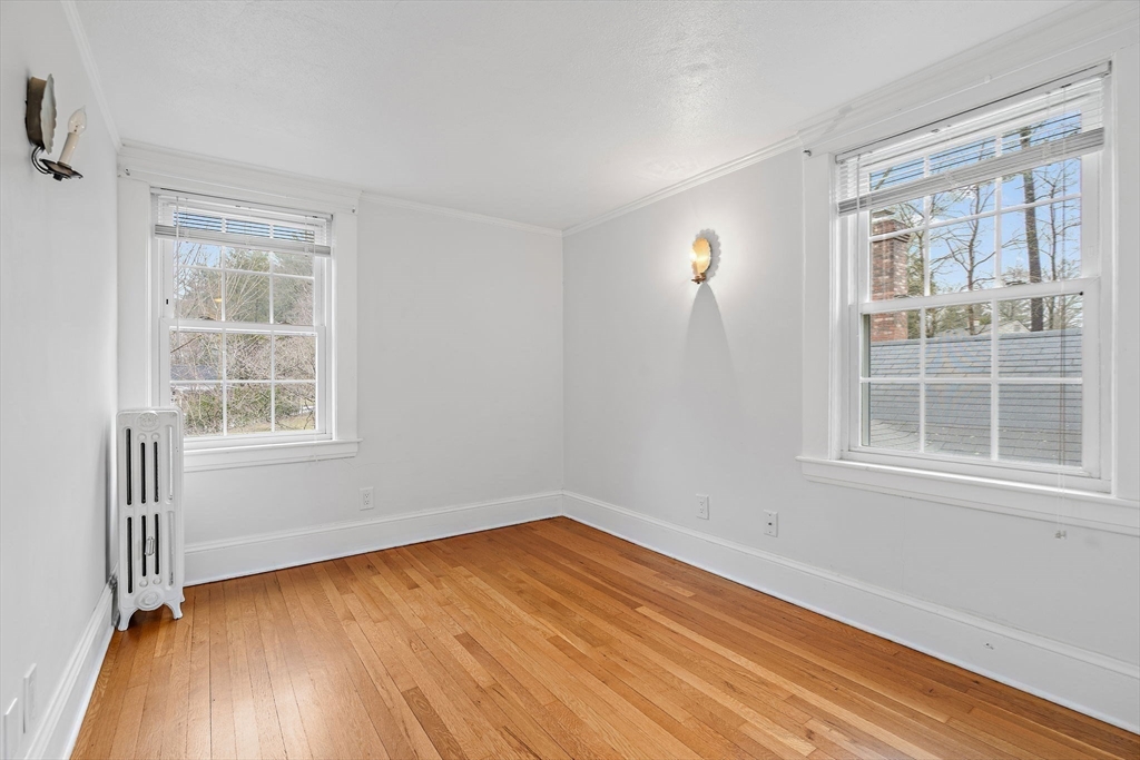106 Lewis Avenue Walpole, MA 02081 - Photo 28 of 36 an empty room with wooden floor and windows