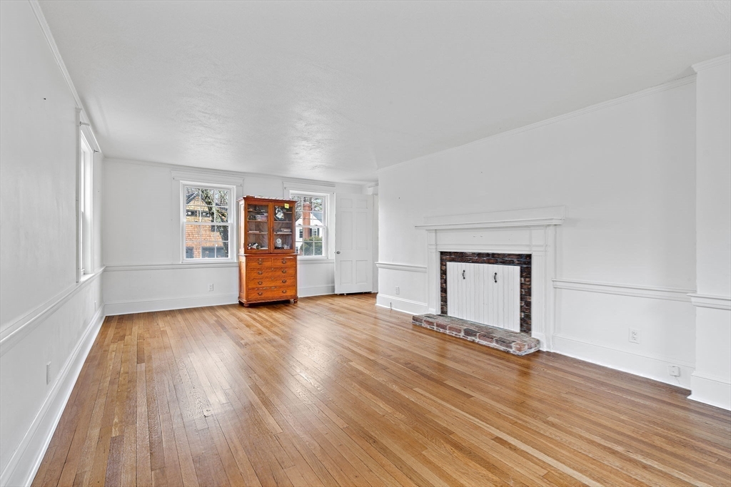 106 Lewis Avenue Walpole, MA 02081 - Photo 29 of 36 an empty room with wooden floor and window