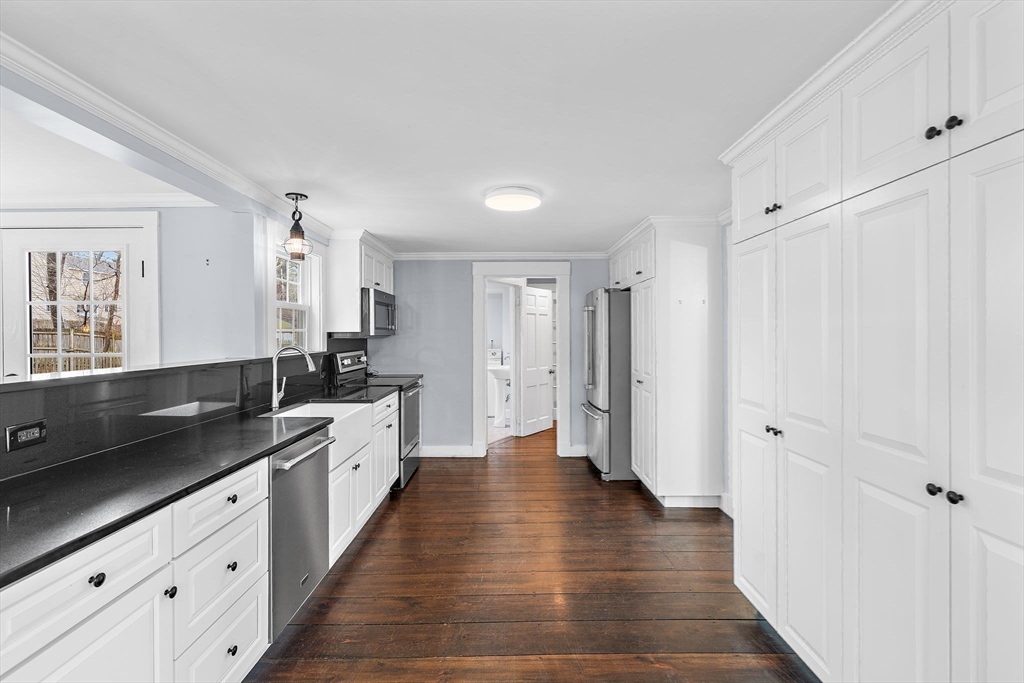 106 Lewis Avenue Walpole, MA 02081 - Photo 7 of 36 a large white kitchen with stainless steel appliances granite countertop a refrigerator and a sink