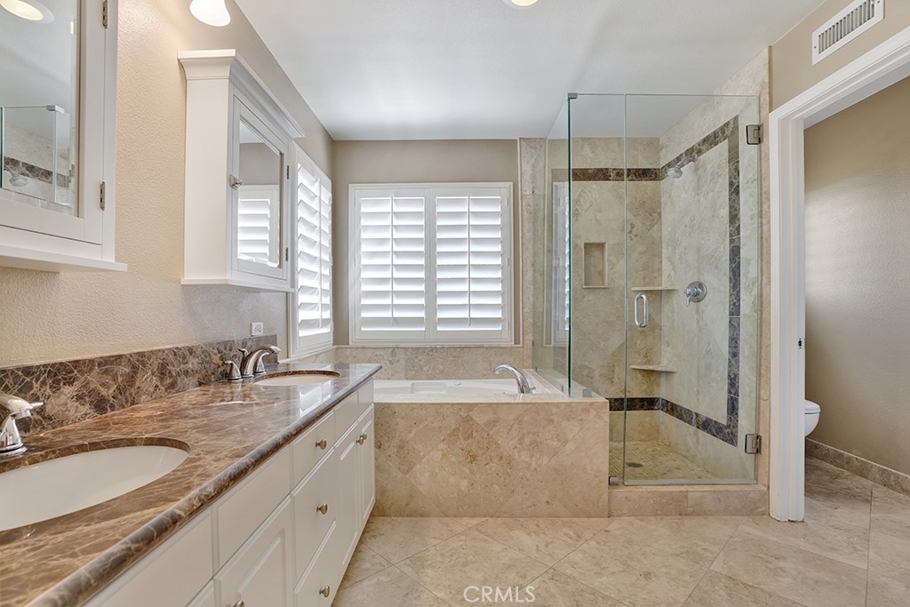 27585 Rosebud Way Laguna Niguel, CA 92677 - Photo 12 of 35 a bathroom with a granite countertop tub sink shower and mirror