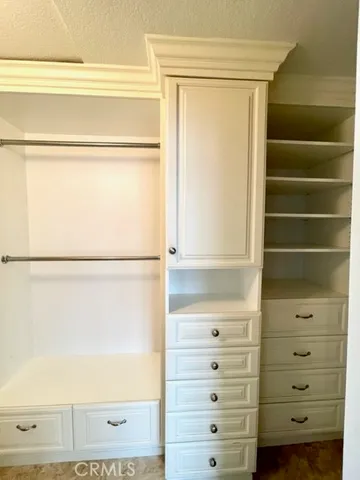 a view of empty room with fireplace and wooden floor