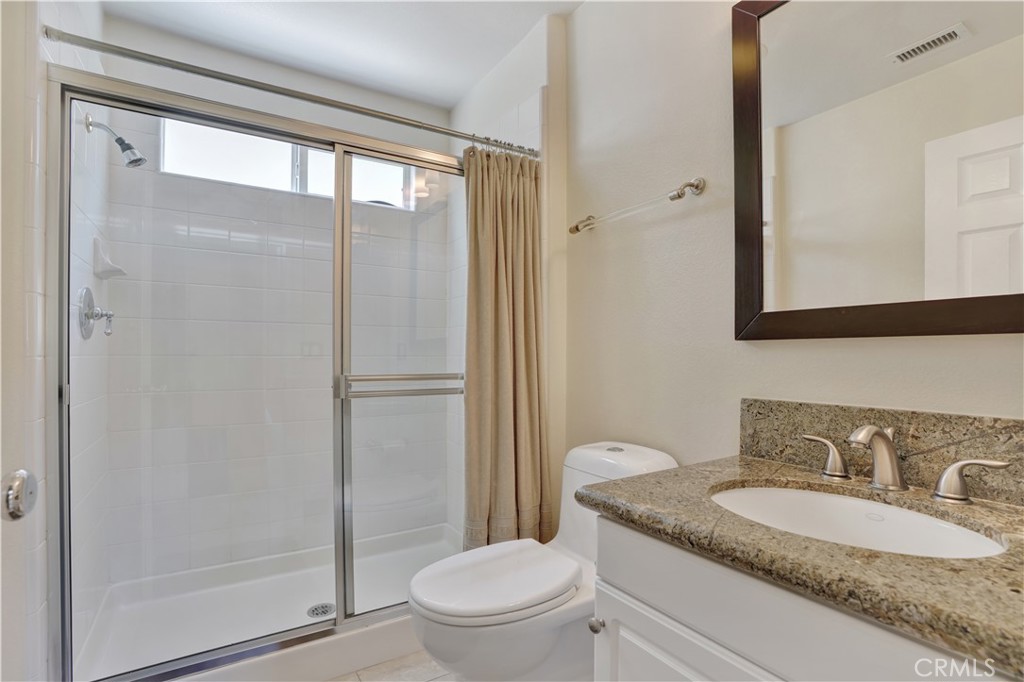 27585 Rosebud Way Laguna Niguel, CA 92677 - Photo 17 of 35 a bathroom with a granite countertop sink toilet and shower
