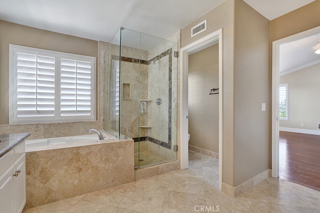 27585 Rosebud Way Laguna Niguel, CA 92677 - Photo 10 of 35 a spacious bathroom with a tub shower and windows