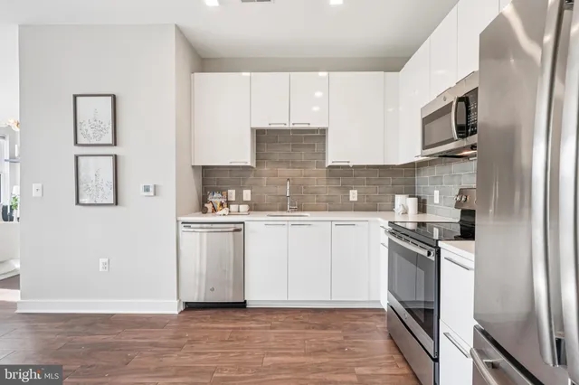 a kitchen with stainless steel appliances granite countertop a stove top oven a sink and dishwasher