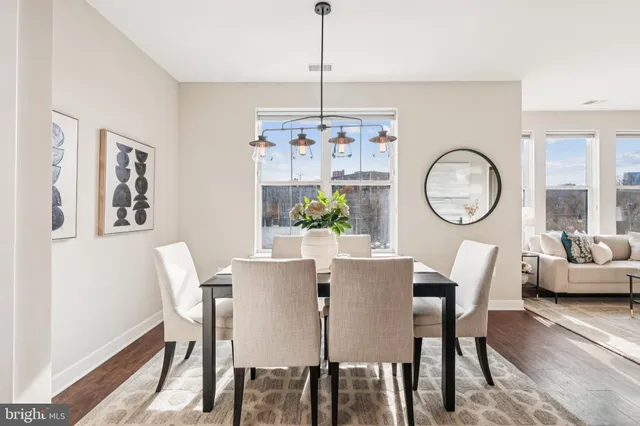 a view of a dining room with furniture window and wooden floor