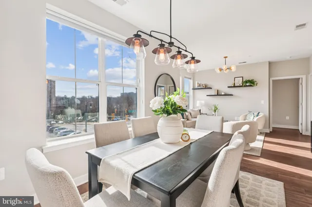a view of a dining room with furniture large windows and wooden floor