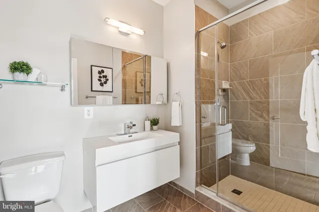 a bathroom with a toilet sink and shower