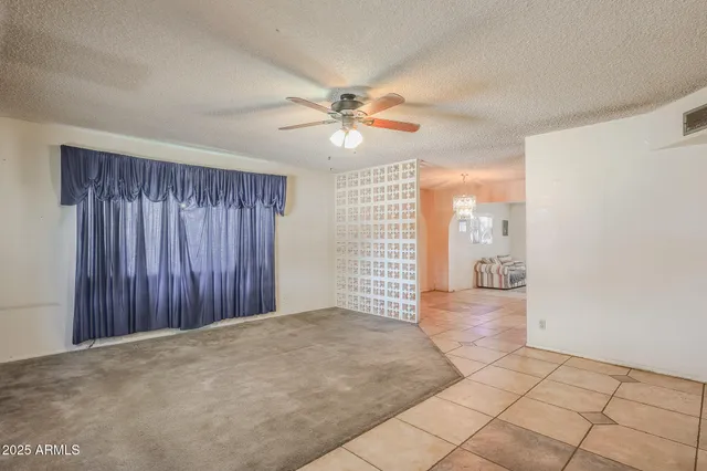 a view of a livingroom with a ceiling fan and window