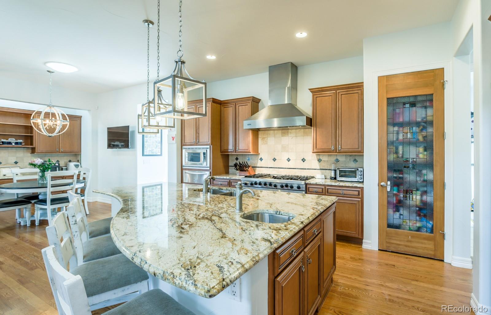 2322 Spruce Way Denver, CO 80238 - Photo 15 of 40 a kitchen with stainless steel appliances granite countertop a stove oven and a refrigerator