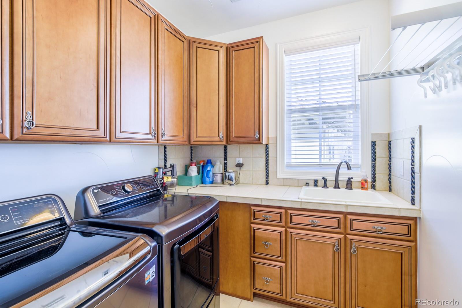 2322 Spruce Way Denver, CO 80238 - Photo 27 of 40 a kitchen with stainless steel appliances granite countertop a sink a stove and cabinets