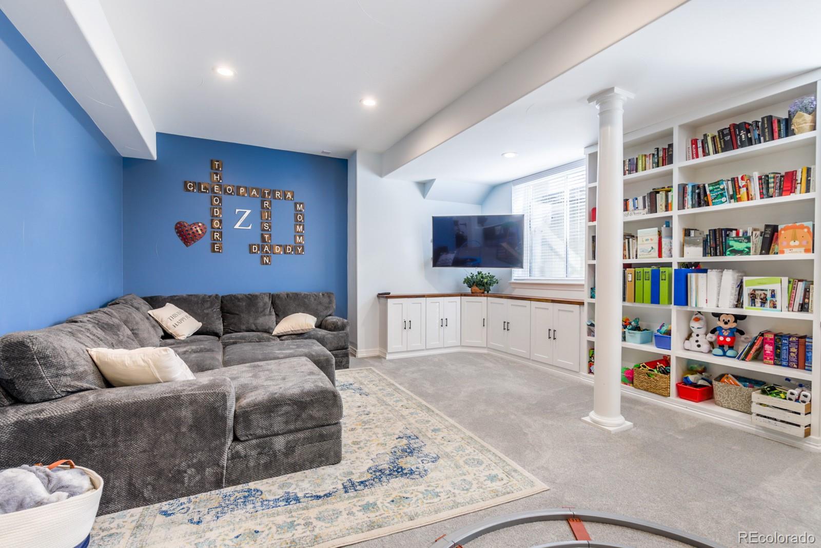 2322 Spruce Way Denver, CO 80238 - Photo 30 of 40 a living room with furniture and a book shelf