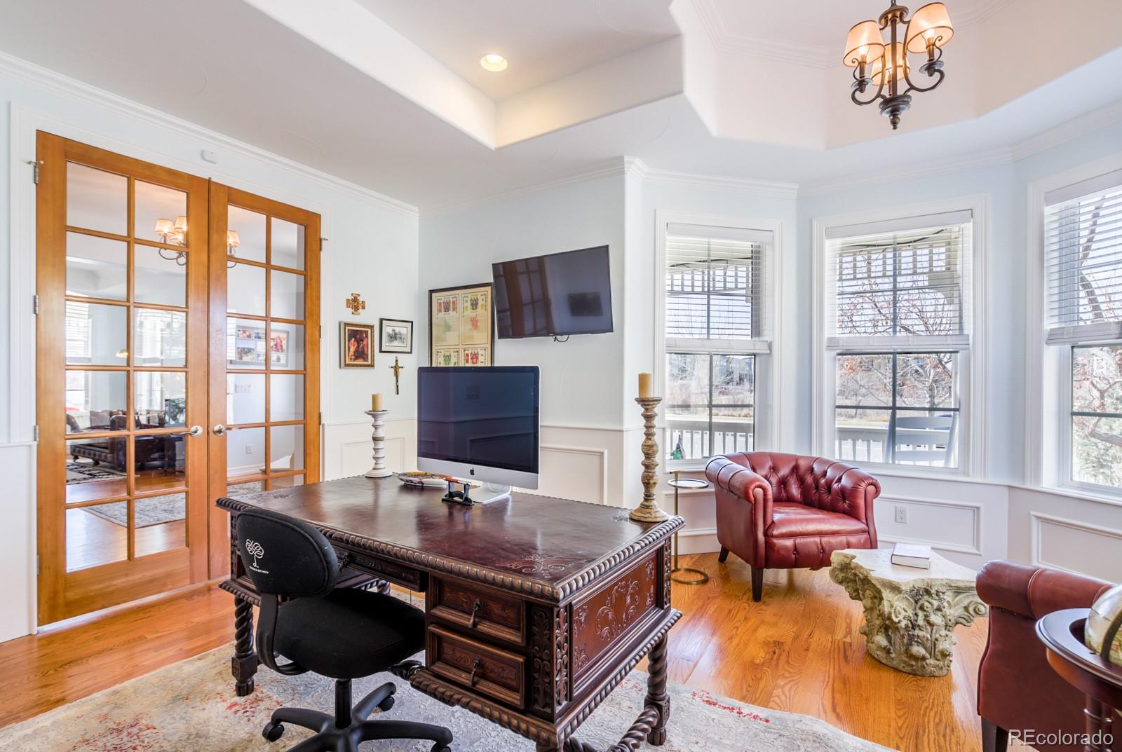 2322 Spruce Way Denver, CO 80238 - Photo 9 of 40 a living room with furniture a flat screen tv and a floor to ceiling window