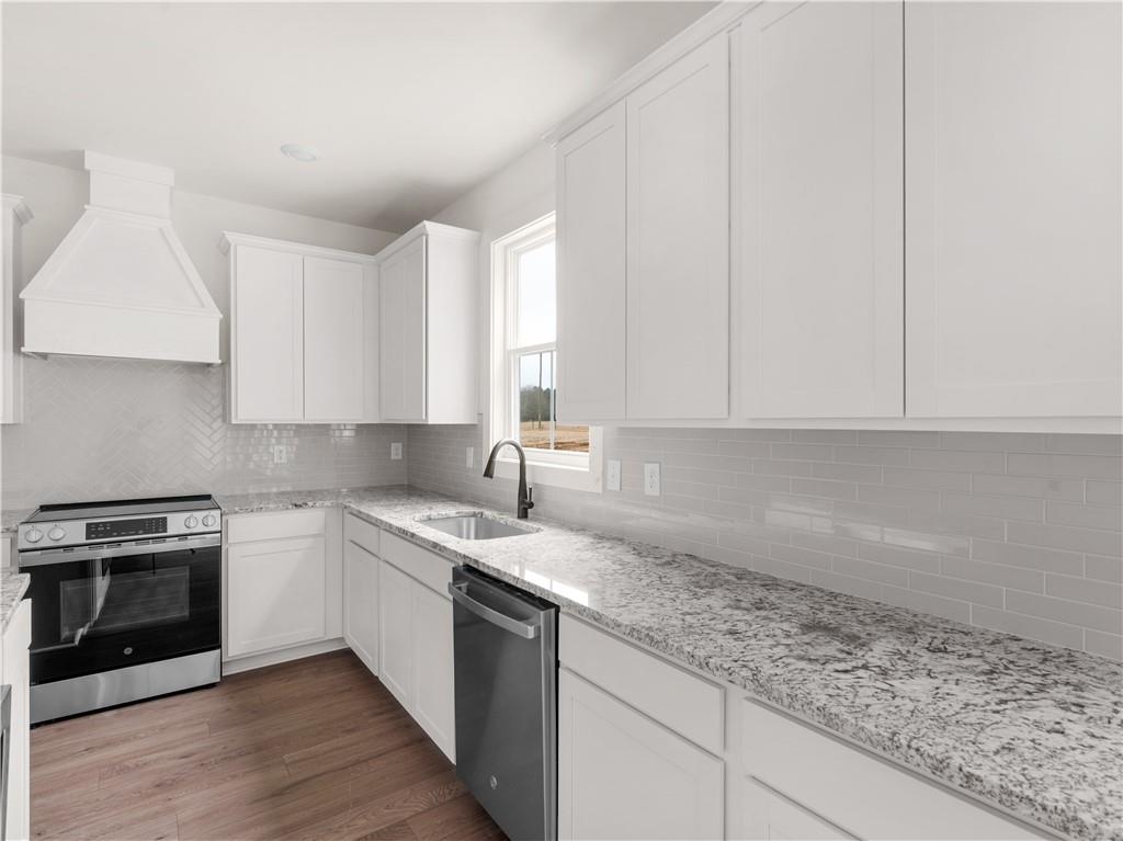 200 Loyd Road Mansfield, GA 30055 - Photo 13 of 54 a kitchen with granite countertop white cabinets and white stainless steel appliances