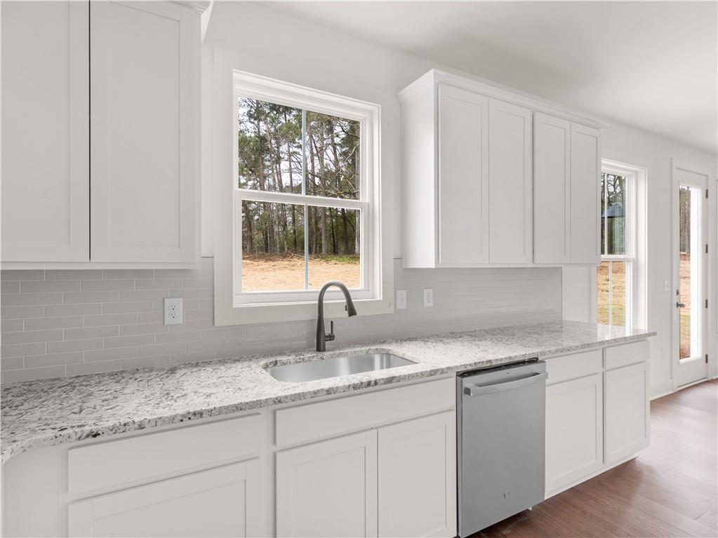 200 Loyd Road Mansfield, GA 30055 - Photo 15 of 54 a kitchen with granite countertop white cabinets and window