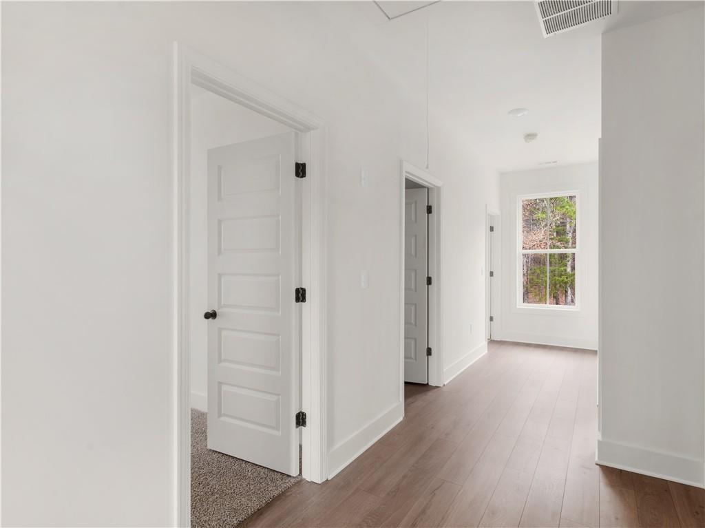 200 Loyd Road Mansfield, GA 30055 - Photo 26 of 54 an empty room with wooden floor cabinet and windows