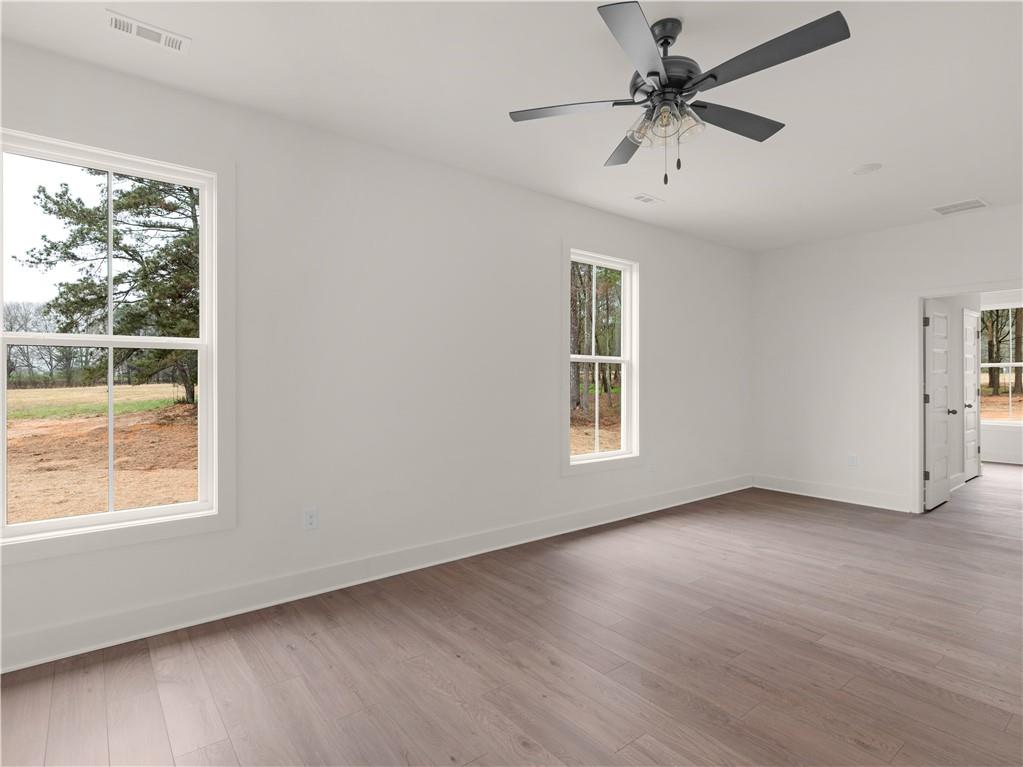 200 Loyd Road Mansfield, GA 30055 - Photo 43 of 54 a view of an empty room with a window and wooden floor