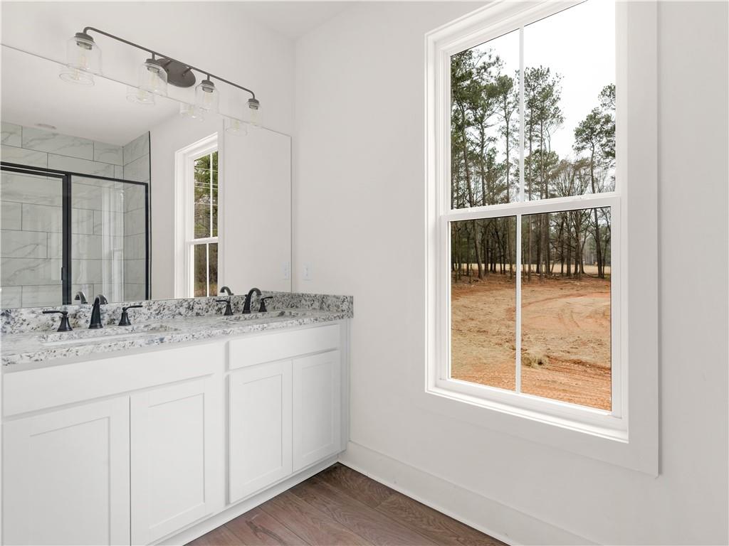 200 Loyd Road Mansfield, GA 30055 - Photo 48 of 54 a bathroom with a granite countertop sink mirror and a window