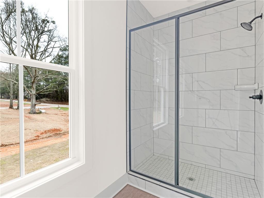 200 Loyd Road Mansfield, GA 30055 - Photo 49 of 54 a bathroom with a glass shower door