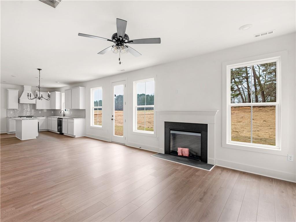 200 Loyd Road Mansfield, GA 30055 - Photo 8 of 54 a view of an empty room with wooden floor fireplace and a window