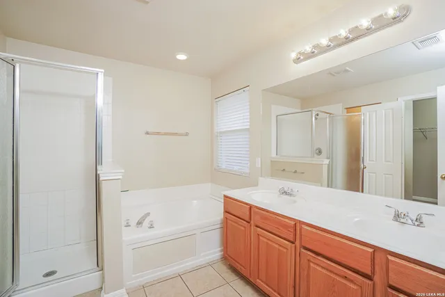 a bathroom with a tub sink and mirror