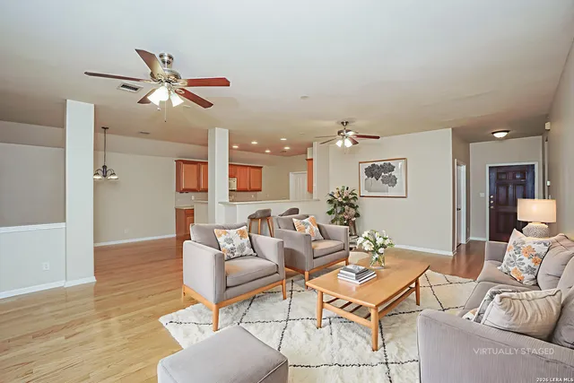 a living room with furniture and a wooden floor