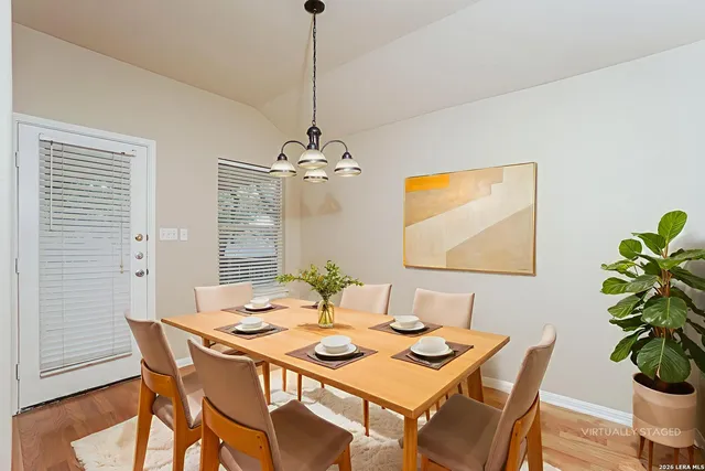 a view of a dining room with a table and chairs