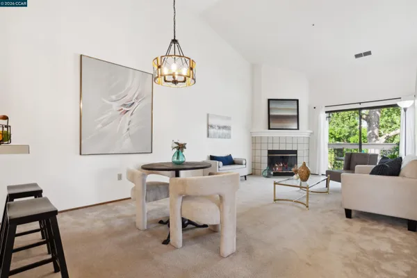 a view of a livingroom with furniture window and a chandelier