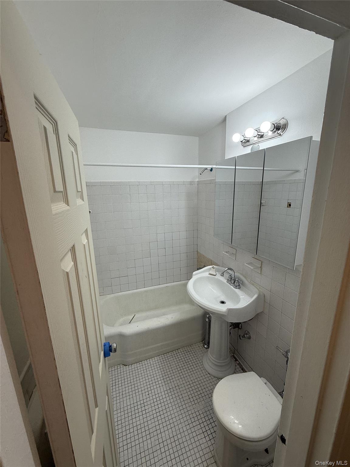 83-30 Vietor Avenue, Unit 727 Queens, NY 11373 - Photo 11 of 11 a bathroom with a sink toilet a mirror and shower